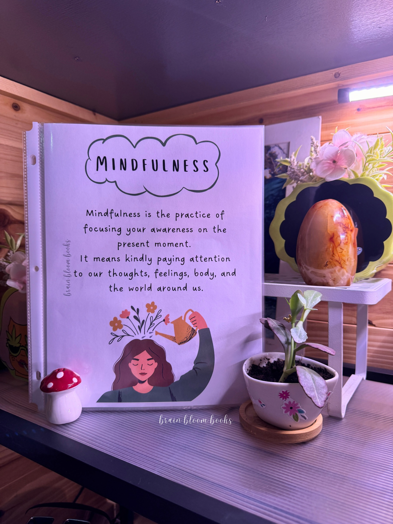 Page from children’s mindfulness activity & coloring book: definition of mindfulness, with a graphic of flowers blooming from the top of a woman’s head.